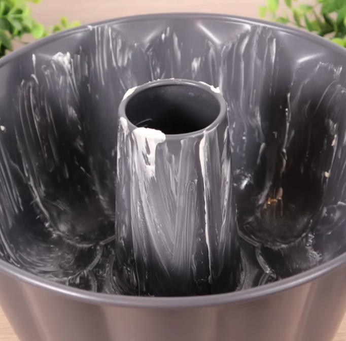 Fill bundt pan with pasta and fetta cheese then top with milk for