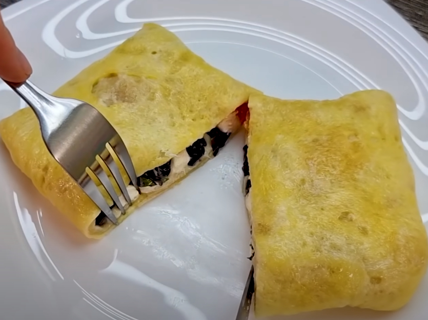 Pour an egg into tortilla sitting in frying pan for a new breakfast favorite